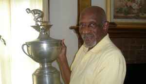Olympic Gold medalist Harrison Dillard holding one of his trophies